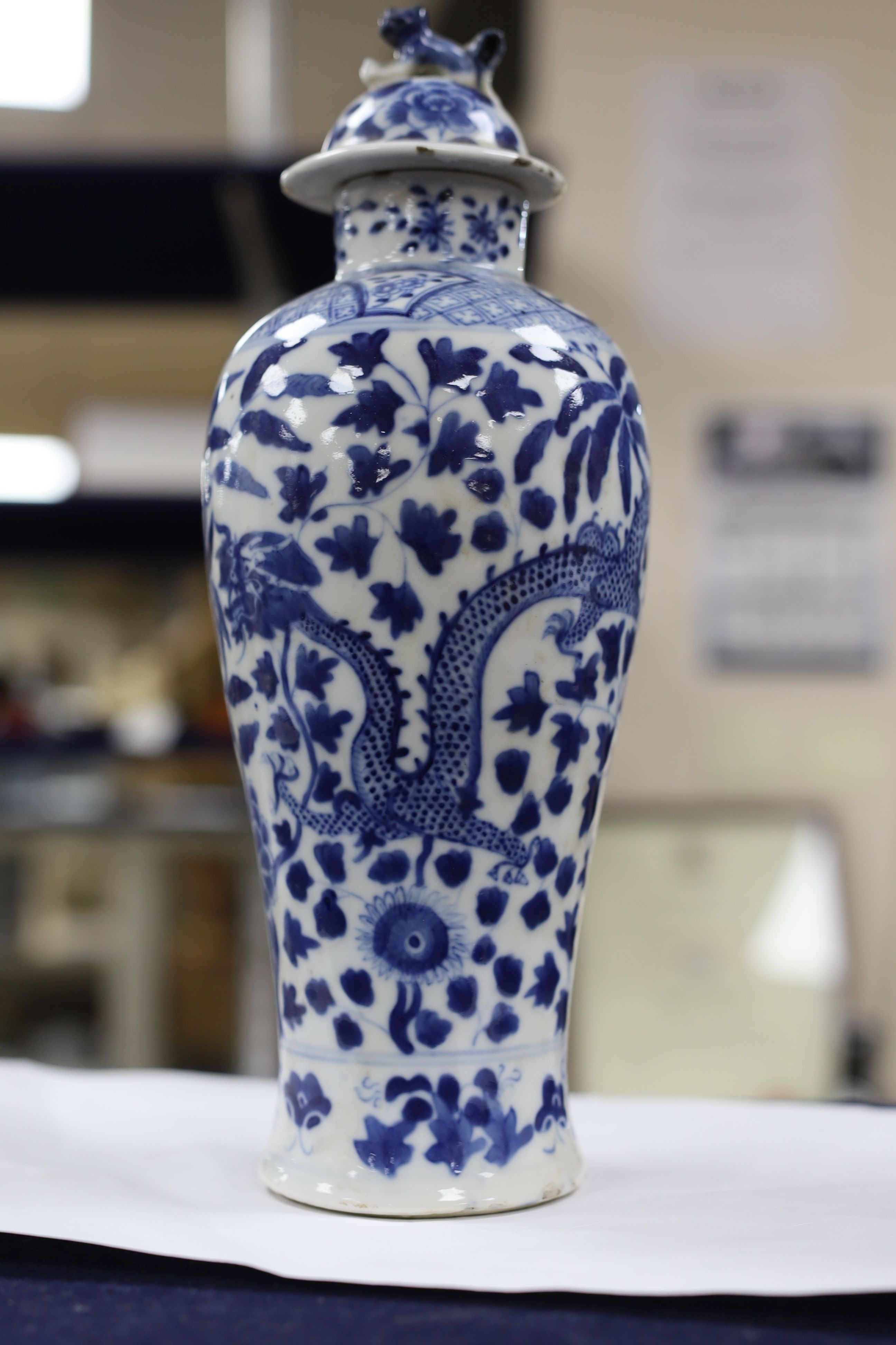 A pair of Chinese blue and white dragon vases and covers, circa 1900. 28cm